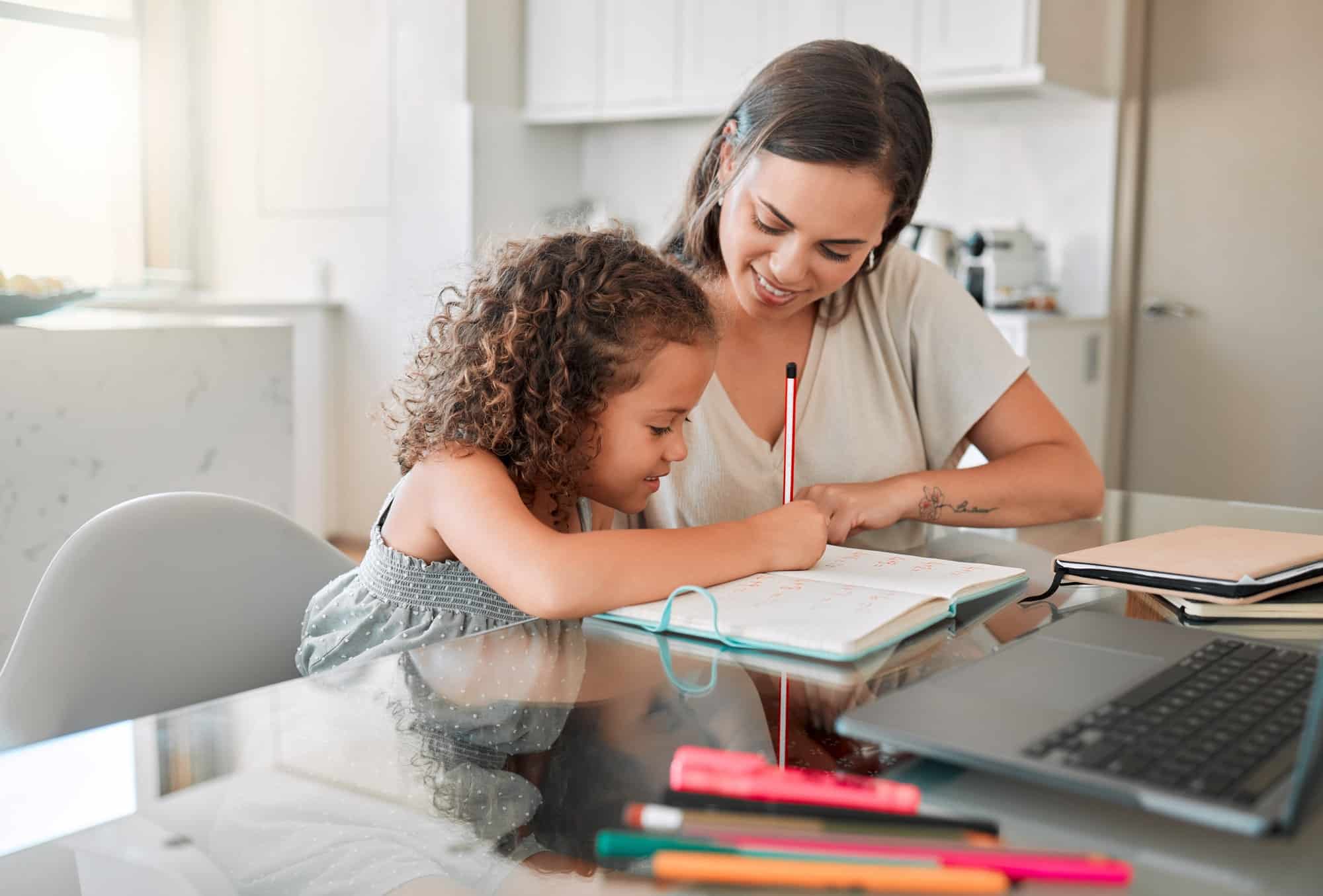 Family, education and remote learning mother helping her child student with her school work. Smilin