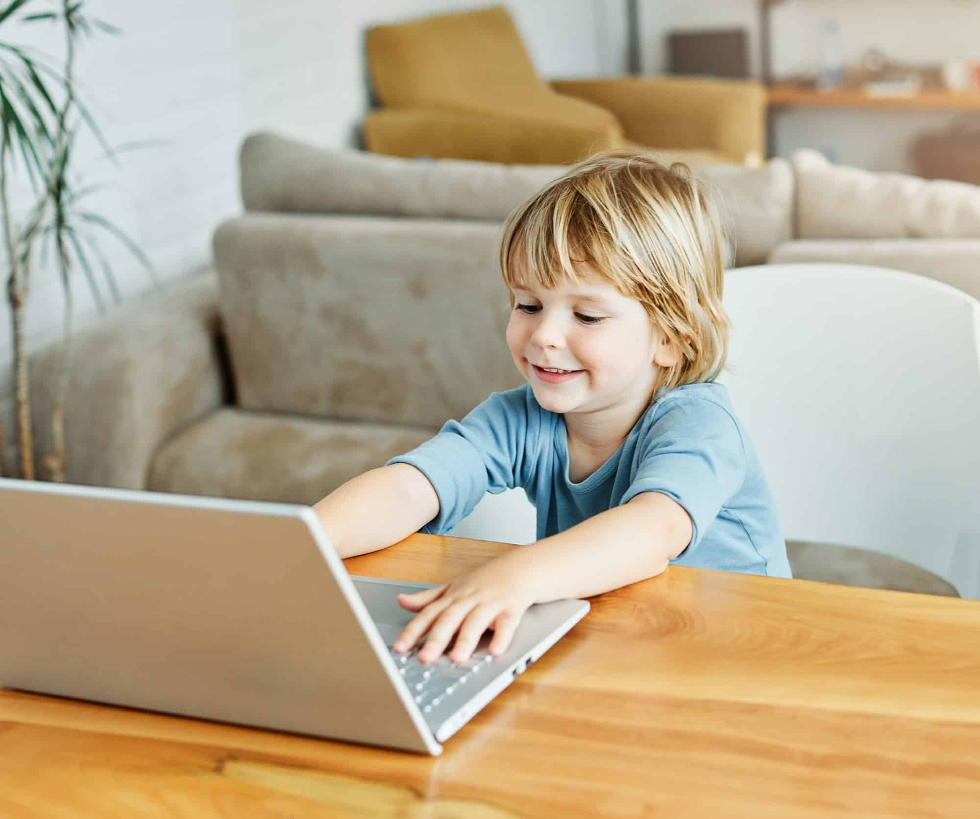 child laptop computer technology home boy son man education homework kid learning internet childhood