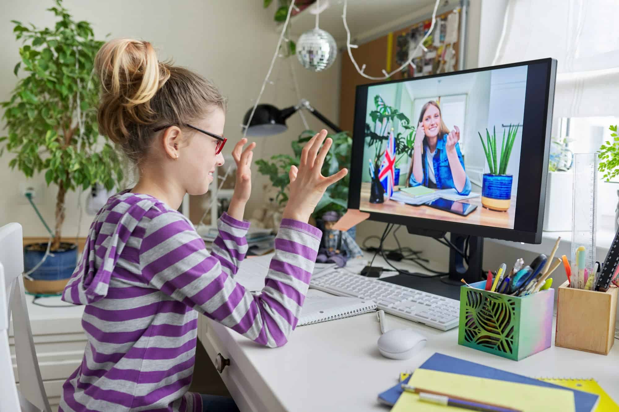 Online learning, little student girl learning language remotely with an English teacher